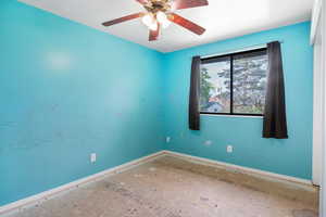 Empty room with baseboards and ceiling fan