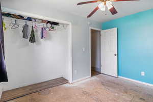 Unfurnished bedroom with a ceiling fan and wood finished floors