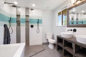 Full bathroom with walk in shower, tile patterned floors, and double vanity