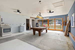 Recreation room with pool table and unfinished concrete floors