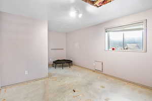 Spare room featuring concrete floors