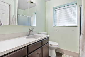 Full bath featuring vanity and a shower with shower door