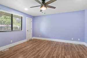Spare room with ceiling fan and wood finished floors