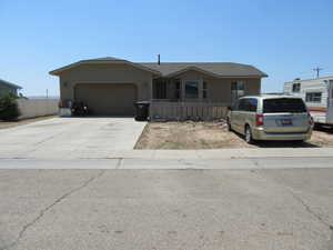 View of front of house with a garage and concrete driveway