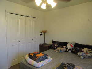 Bedroom 2 featuring a closet, carpet flooring, and ceiling fan