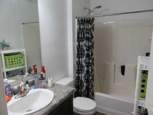 Full bath featuring vanity and shower / bath combo
