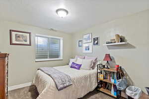 Carpeted bedroom featuring baseboards
