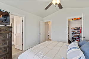 Bedroom with vaulted ceiling and ceiling fan