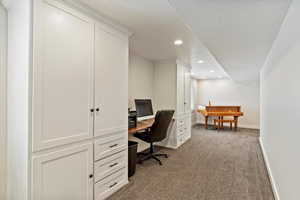 Office with carpet floors and recessed lighting