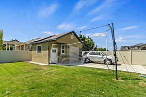 View of front of house with a fenced backyard and stucco siding