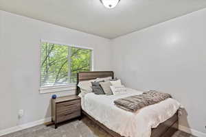 Bedroom with carpet floors and a textured ceiling