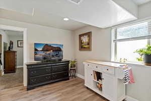 Living area featuring light wood-style flooring and recessed lighting