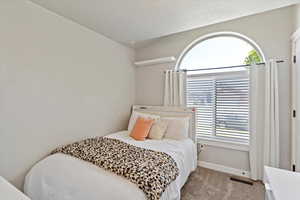 Carpeted bedroom featuring baseboards
