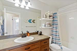 Bathroom featuring vanity and shower / tub combo with curtain