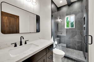 Bathroom with vanity and a shower stall