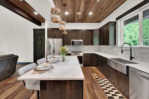 Kitchen featuring appliances with stainless steel finishes, wood ceiling, recessed lighting, dark brown cabinets, and decorative backsplash