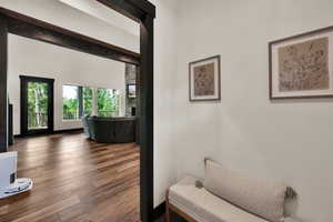 Hall with wood finished floors and baseboards