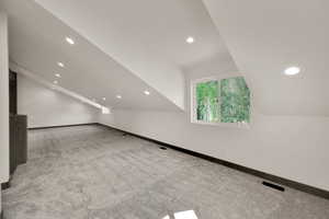 Additional living space featuring carpet, recessed lighting, and vaulted ceiling