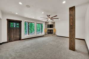 Unfurnished living room with carpet, recessed lighting, a ceiling fan, and a fireplace