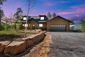 Chalet / cabin with driveway and a garage