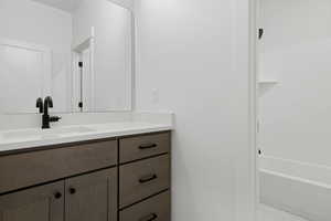 Full bath featuring vanity and shower / tub combination