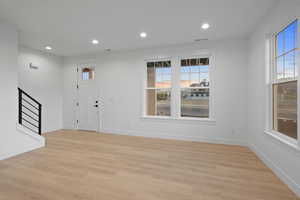 Foyer featuring light wood-style floors and recessed lighting
