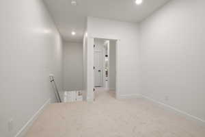 Unfurnished room featuring recessed lighting, a smoke detector, and carpet flooring