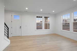 Foyer featuring plenty of natural light, light wood-type flooring, and recessed lighting