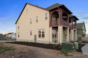 View of home's exterior featuring a balcony and stucco siding