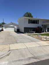 View of front of home featuring a detached garage and an outdoor structure