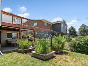 Large deck with patio underneath. Raised bed gardens