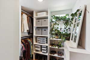 Walk in closet with natural lighting. Connected to Primary bedroom on main level.
