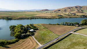 View of property location featuring a water and mountain view and rural landscape