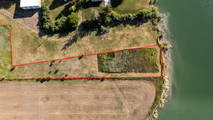 Aerial overview of property's location featuring property parcel outlined and a nearby body of water