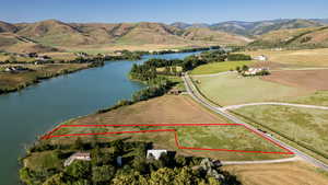 Aerial overview of property's location with a water and mountain view and property boundaries highlighted