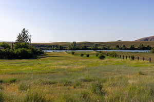 View of mountain backdrop with rural landscape
