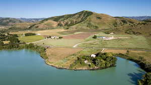 Aerial overview of property's location with a water and mountain view and rural landscape