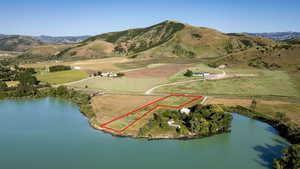 View of property location featuring property boundaries highlighted, a water and mountain view, and rural landscape