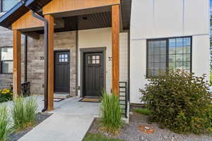 Doorway to property featuring covered porch