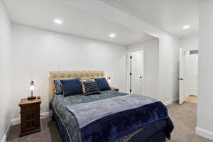 Carpeted bedroom with recessed lighting