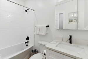 Bathroom with vanity and bathing tub / shower combination