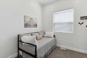 Carpeted bedroom featuring baseboards