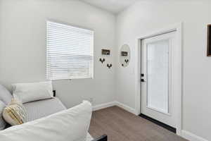 Sitting room featuring carpet flooring and baseboards