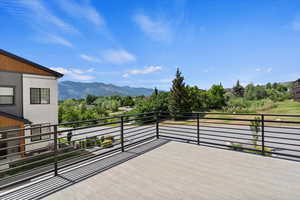 Wooden terrace featuring a mountain view