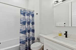 Bathroom with vanity and shower / bath combo with shower curtain