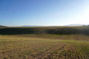 View of mountain backdrop featuring rural landscape