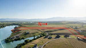 Aerial view of property and surrounding area with a water and mountain view and property boundaries highlighted