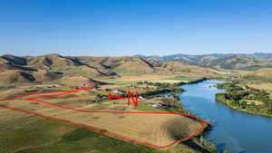 Aerial view of property's location featuring a water and mountain view and property parcel outlined