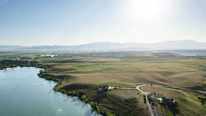 Aerial view of property and surrounding area with a water and mountain view