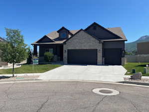 View of front of property featuring an attached garage and concrete driveway